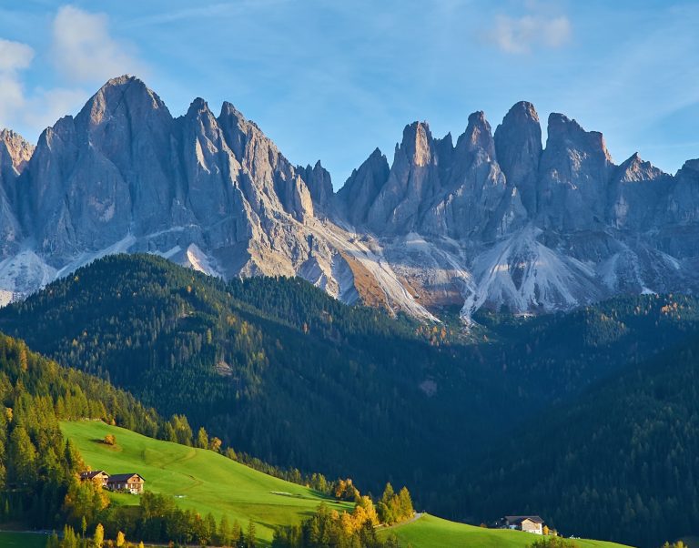Mountain peaks above a green valley under a clear sky